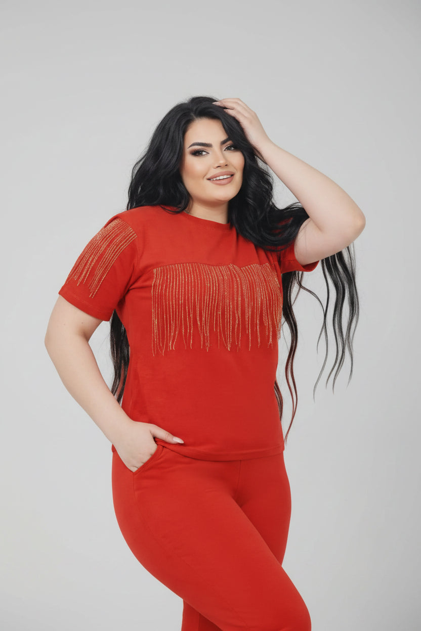 Red outfit with fringe details on a model against a white background